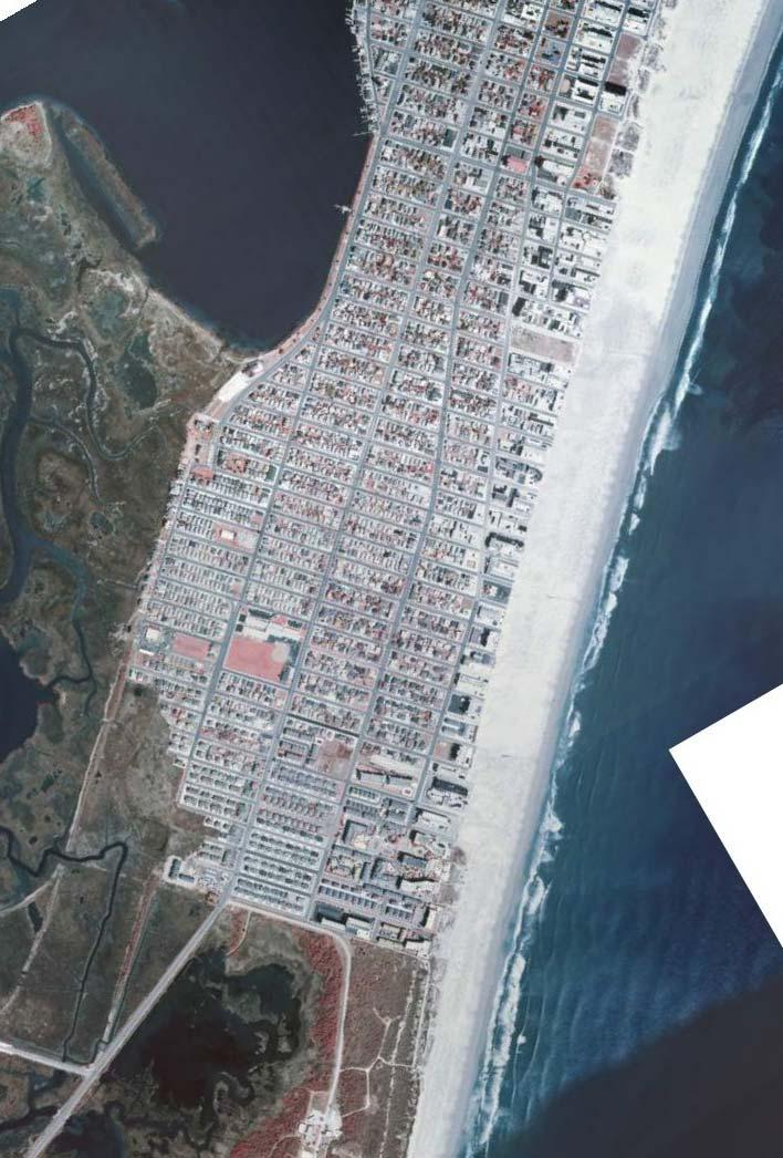 The barrier island has expanded about three blocks seaward over the 82 year period.