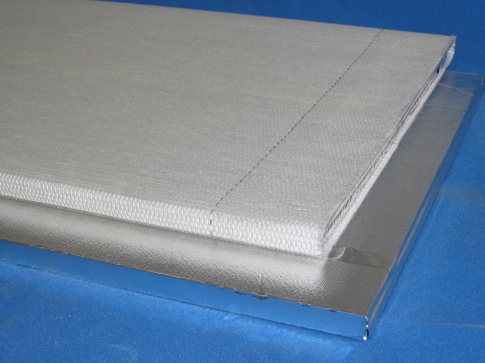 2). The glass fiber envelope either is fixed by an adhesive which covers the whole surface of the high barrier film or one or two double adhesive bands.