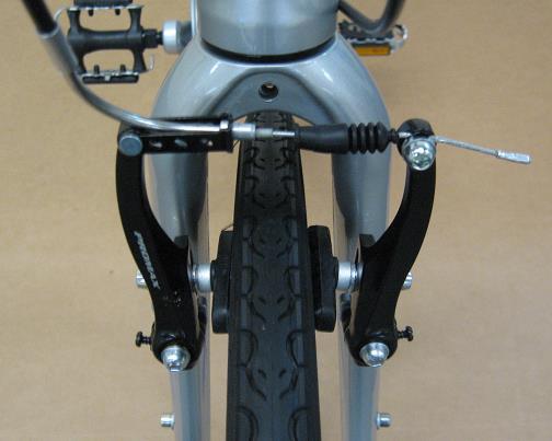 To reconnect after wheel is on, hold the brake arms together and place the silver insert into the cable stop as shown (2-B) or as seen on the