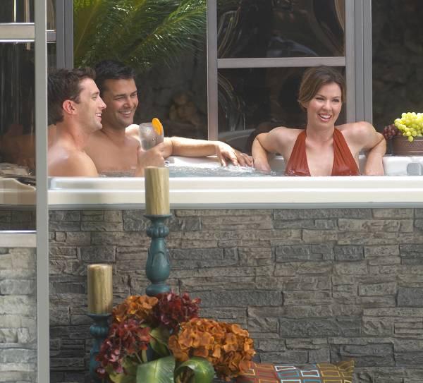 Avalon 857 in Cal Stone within a gazebo environment Family series hot tubs are designed to accommodate between three and six people and are equipped with 15 to 45