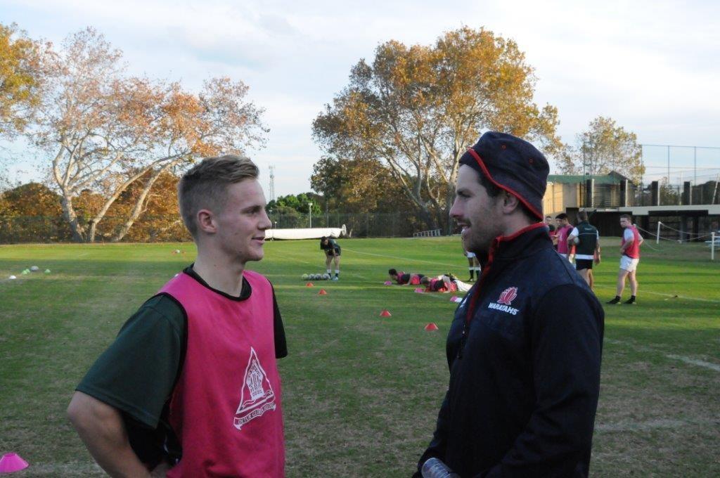 Cooper Chambers (12WJ), Trinity captain of Rugby, enjoying a conversation with the Wallaby and Waratah fly-half, Bernard Foley.