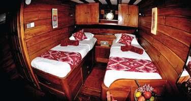 spacious cabins crafted in rich wooden hues each with private baths, comfortable