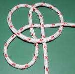 To tie this knot, lay out the rope on a table and follow the over and