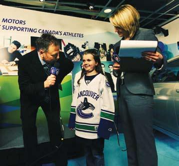 while Kristin Reid looks on. Gina Luongo takes some time on the phone at the Canucks for Kids Fund Telethon.