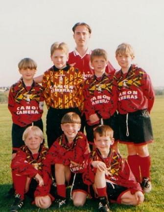 Here are 2 pictures of his early teams with his managers at the back. On the left at Under 8s and on the right at Under 9s.