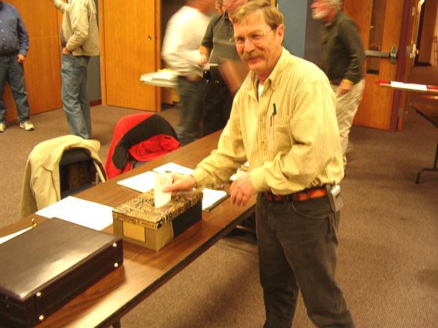 Member Jon Perry puts his vote in the ballot box at the November elections. (Photo by Jim Cook) Allan Boucher and Bernie Gaub were running for out-going secretary Pat Dziuk s seat.