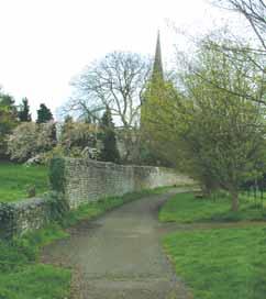 There is a gate on the right into the churchyard, where there are a number of yew trees.