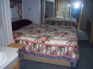 Queen size bed in 5th wheel, microwave, stove, refrigerator--free standing table and chairs.