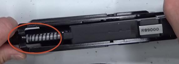 the tab on the bottom catches the recoil spring.