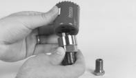 If the selected cutter requires a hole saw adapter, screw it into the end of the extension.