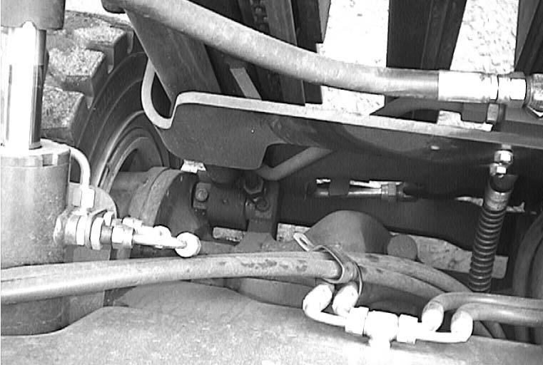 Remove bolt(5) from each side of mast assembly(2). 5.