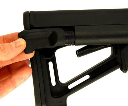 press the lower, locking lever to lock the buttstock, minimizing the movement between the buffer tube and
