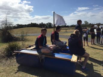 The Youth helpers build a flag pole on their Sample RAFT.