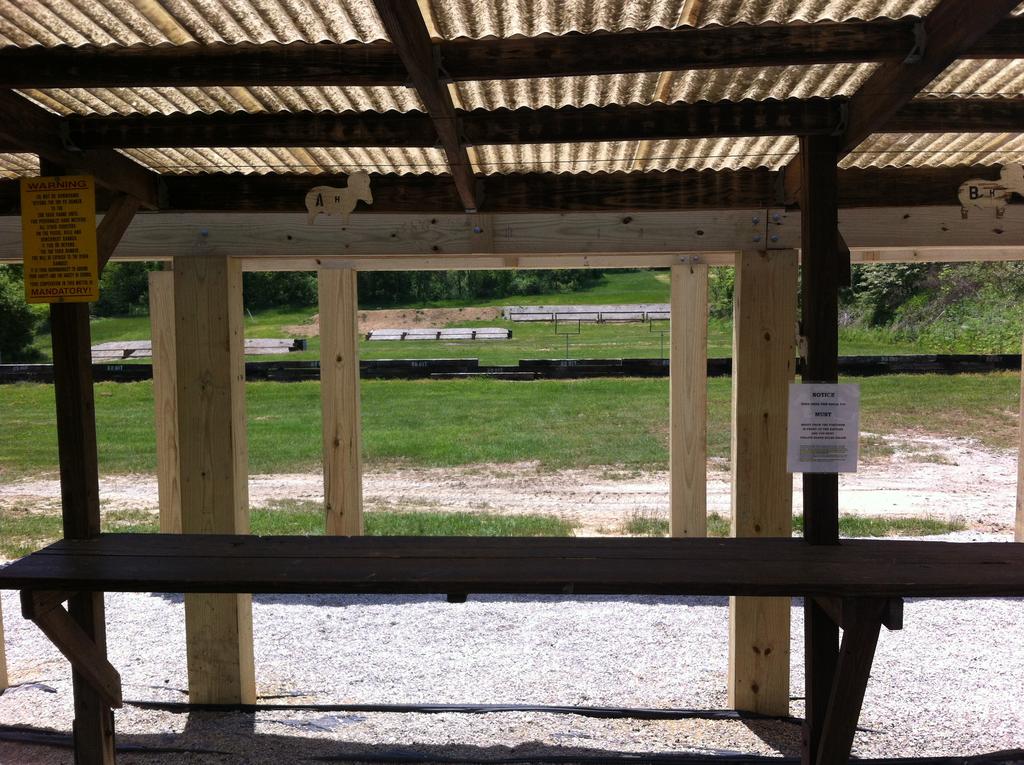 The picture to the le shows what the baﬄe system looks like from the ﬁring line. Shots will pass between the posts and under the baﬄes. All shoo ng must take place from underneath the pavilion.