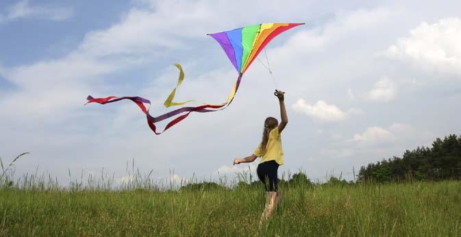 On a breezy day, take your kite to a flat, open area. Be sure that there are no power lines or big trees. Look at the ground around you. Is there anything you could trip over?