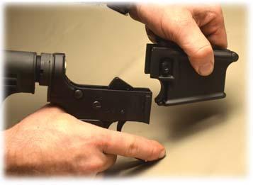 6) Then slide the Magazine Well of your choice down onto the Lower Receiver while again pushing in on the Magazine Catch Bu on.