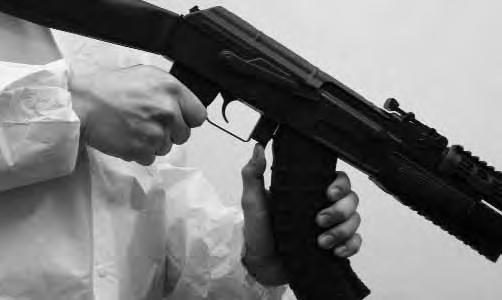 . To remove the magazine from the rifle while holding the rifle in the firing position, simply slide your left hand from the lower handguard to the magazine.