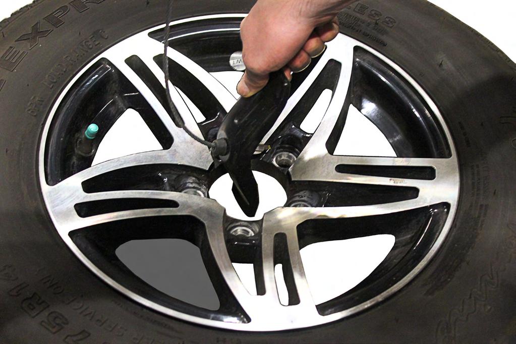 20A) or with a hand wrench, lower (counter-clockwise) or raise (clockwise) the tire.