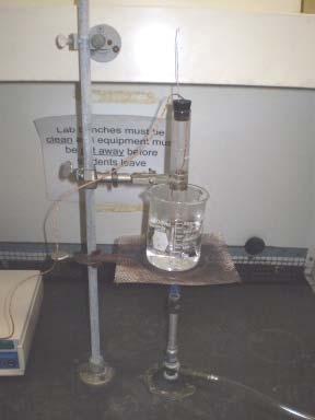 Put about 300 ml of water into the beaker, place the beaker upon a wire gauze supported by a ring stand, and heat the water to boiling using a Bunsen burner.