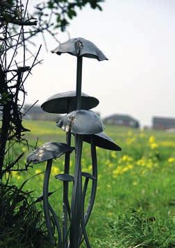 WALKING IN COUNTY DURHAM A peculiar mushroom sculpture stands halfway round the short walk at Ouston and Urpeth and continue along the foot of a wooded slope. The path eventually climbs up to a stile.