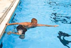 3. Extend your arms in front of you, in the direction you intend to go. 4. Push off the bottom or kick your legs to help move your body into a horizontal position, and then start swimming.