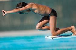 2. Extend your arms overhead with your upper arms pressing together against your ears. 3. Focus on a target on the surface of the water about 4 feet from the end of the springboard. 4. Reach toward the water, dropping your hands and head.