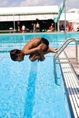 One-part takeoff with forward dive tuck from poolside 1. Stand at the edge of the deck with your arms overhead. Focus on a target at a 45 angle across the pool.
