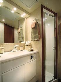 Head (above): The 42 s head features a full stall shower w/seat, a vanity with a one-piece molded top and sink, medicine cabinet w/mirror, air conditioning w/reverse cycle heat, opaque overhead hatch