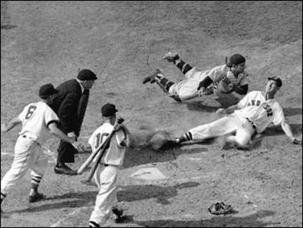 " Yogi Berra tags the sliding Philadelphia Phillies shortstop Granny Hamner for an out at home plate during the 4 th inning in the final World Series game at Yankee Stadium, October 7, 1950.