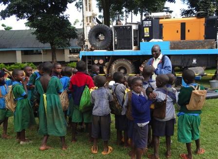 Secondary school children gather at the drill rig to learn about safe hygiene and