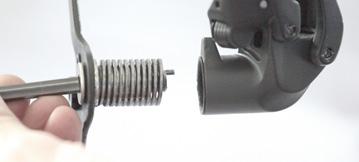 Once the pulley pivot bolt is free, carefully extract the entire pulley cage pivot assembly.