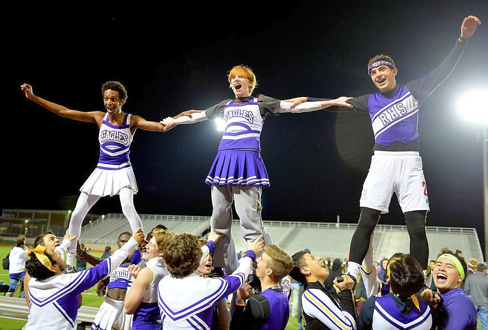During the second half of the annual Powder Puff Football game, sophomore Jack Macy, senior Jesus Casiamano and junior Nathan Abraham fly above the rest of the cheer squad as they cheer on the