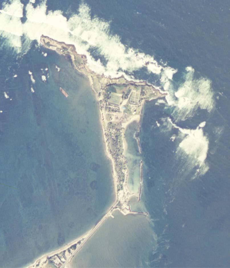 Figure 10. Isla Cabras and the east side breakwater. In 2000, rebuilding was required on the breakwater. Exposed coconut palms and damage to the breakwater showed continuing erosion.