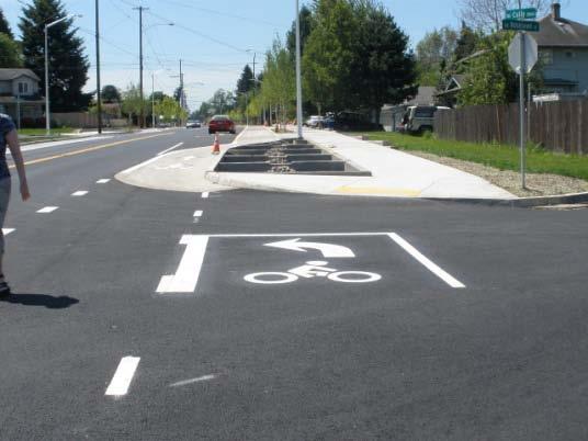 A two stage left turn bicycle box allows a cycle track user to do exactly that.