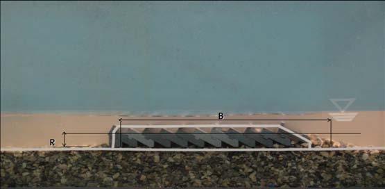 The beach started with the slope of 1/10 for 2m distance and changed the slope with 1/30 until the flat section. The model of the submerged breakwater was installed at the toe of the flat section.