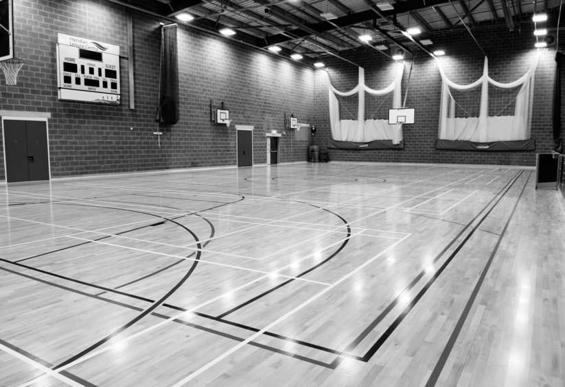 Sports Sports Hall Four badminton court sports hall with markings for basketball, hockey, netball, tennis, volleyball and indoor football as well as four bay cricket nets. Sprung wood Junckers floor.