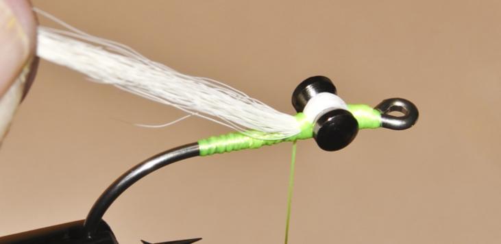 Continue pulling the bucktail back towards the bend of the hook.