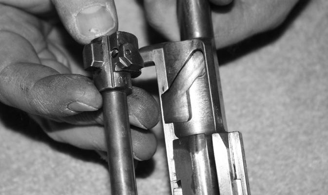 7. Remove the bolt from the bolt carrier by turning the bolt carrier over and holding it in your left hand.