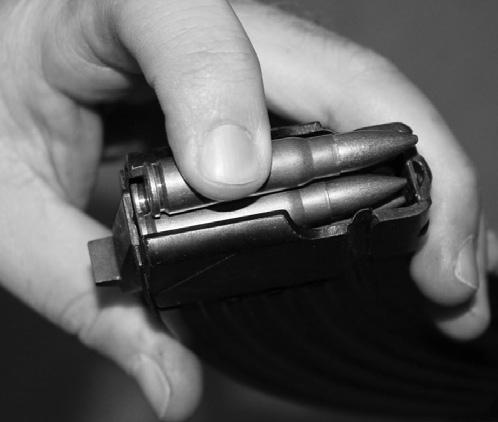 4. Press the round down until it is held by the magazine s lips. (See Illustration #10.) 5.