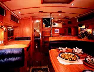 The area to port will seat six adults in comfort while the starboard settee offers a clever fold-down table for light meals, a drink or a