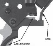 Insert the ACCUTRIGGER supplied tool into the bottom of the trigger return spring as shown, to engage the spring-tail with the slot on the tool.