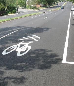 vehicles and bicycles. It appears as a bicycle symbol with 2 chevron markings above. When you see this symbol you are allowed to ride in the full lane.
