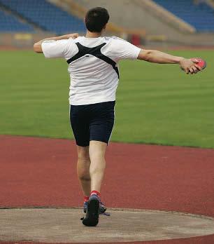 Wind the upper body back, keeping the discus around shoulder height Take a running stride to the middle of the circle Keep the arm long and relaxed