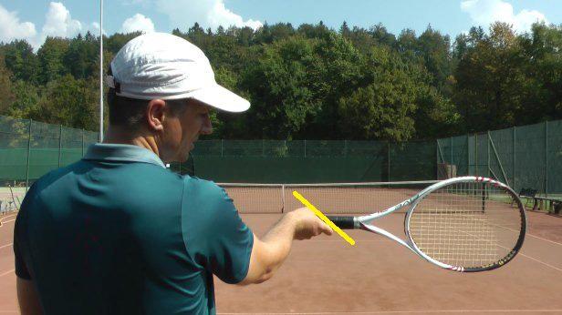 The correct grip would be when we spread the fingers a little bit so that you see the index finger under the racket.
