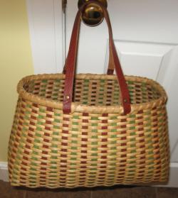 It is woven with all natural reed in different sizes and accented with a ring of seashell. The basket has a unique rim.