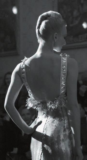 The ballerina first appeared on the runway in the guise of the black swan, then in a golden hued evening dress, and finally in a white lace outfit.