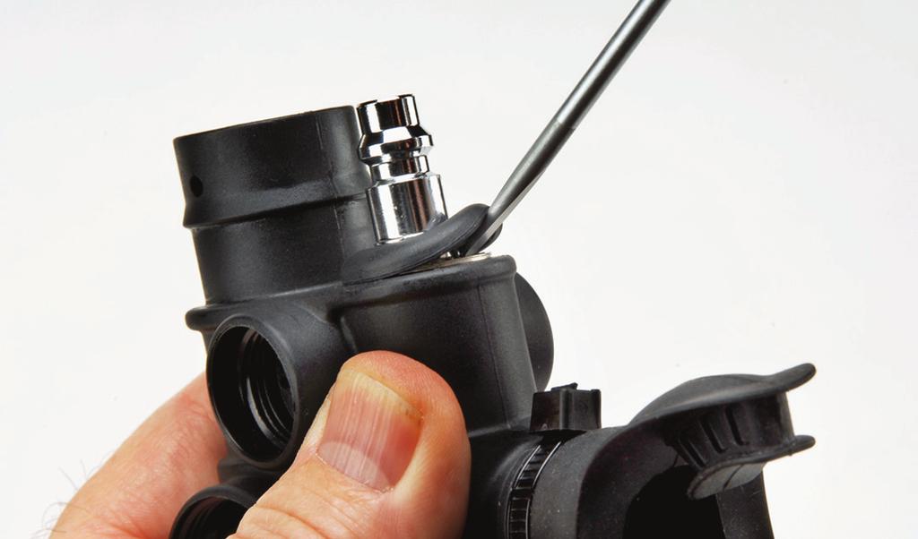 5. Locate the male end of the quick-connect portion of the installed Regulator Valve Body (20) and use a flat blade screwdriver to lift and remove the Retaining Ring Cover (18). 13.