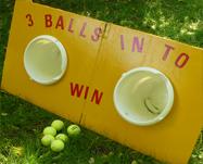throw 3 balls, if one lands in a bucket you win a prize. Large size - 4' wide x 46" high.
