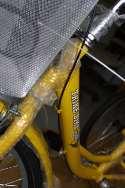 The gear change cable goes from the right-hand handlebar over the top of the basket support and then fits into the cable guides as shown in the