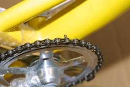 The chain is threaded through the rear gear cluster, through the chain tensioner and then back up to the front sprocket.